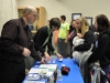 Advancement Assistant Karen Shenk and Business Manager Patrick Farran check in a visitor.